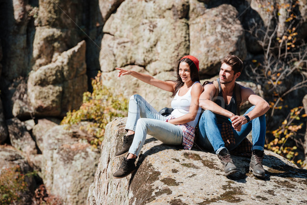Couple taking a break after hiking uphill and pointing finger Stock photo © deandrobot