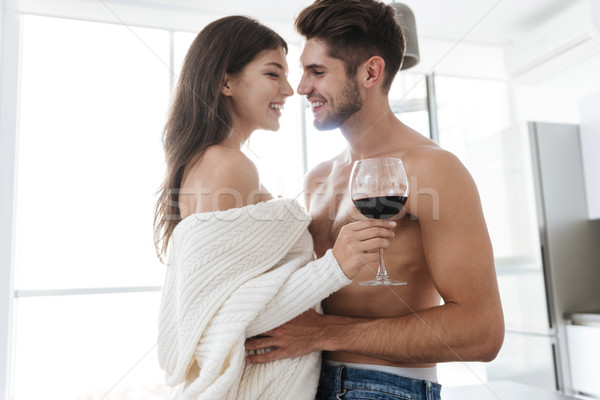 Happy tender young couple drinking red wine together Stock photo © deandrobot