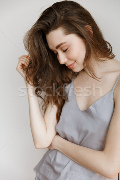 Vertical image of pensive woman in nightie Stock photo © deandrobot