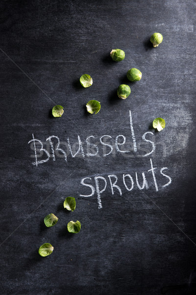 Photo of brussels sprouts over dark background. Stock photo © deandrobot