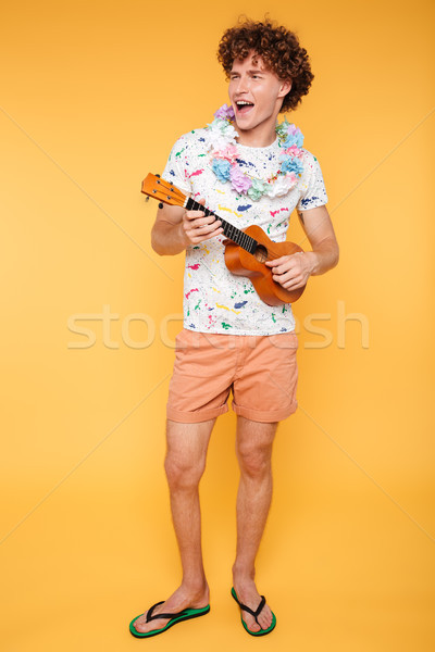 Full length portrait of a happy guy in summer clothes Stock photo © deandrobot