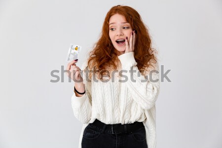 Portrait of a n amused happy asian woman pointing finger Stock photo © deandrobot