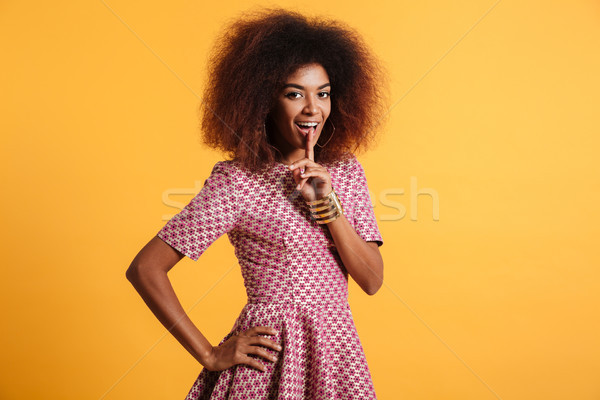Beautiful young african woman with afro hairstyle showing silenc Stock photo © deandrobot