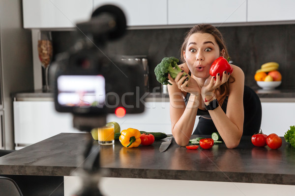 Cheerful healthy young girl recording her blog episode Stock photo © deandrobot