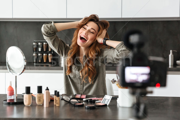 Cheerful young girl recording her video blog episode Stock photo © deandrobot