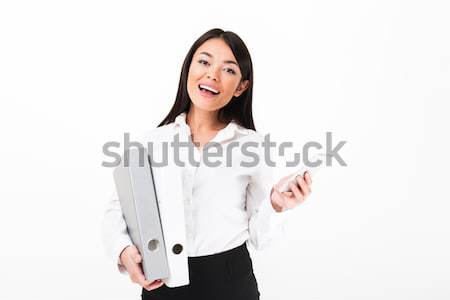 Portrait of a happy asian businesswoman holding binders Stock photo © deandrobot