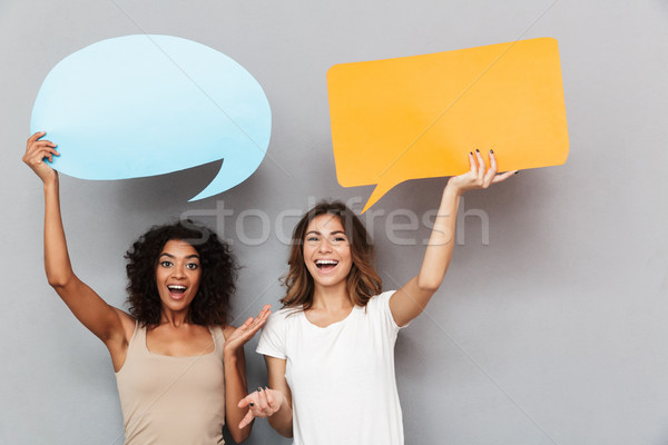 Portrait of two happy young women dancing together Stock photo © deandrobot