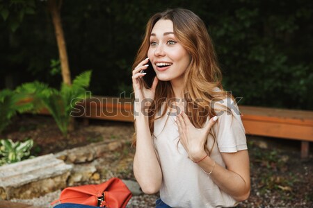 Close up of smiling young girl talking on mobile phone Stock photo © deandrobot