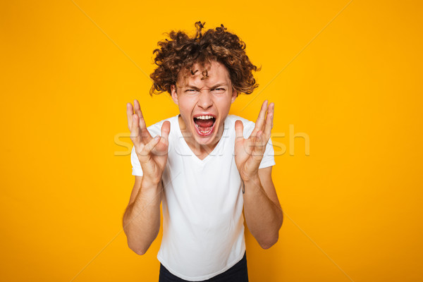 Photo of aggressive or irritated man screaming on camera and rai Stock photo © deandrobot
