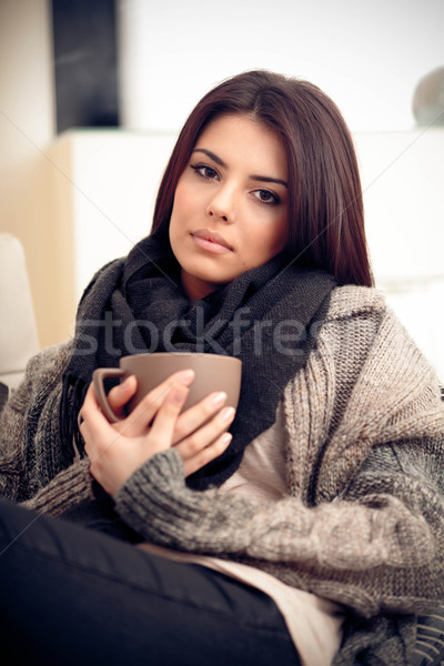 Young pensive woman in cozy warm clothings with cup of coffee Stock photo © deandrobot