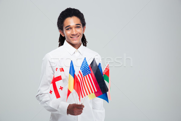 Africano americano empresário mundo bandeiras Foto stock © deandrobot