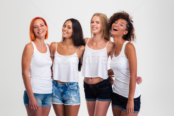 Portret vier lachend vrouwen permanente geïsoleerd Stockfoto © deandrobot