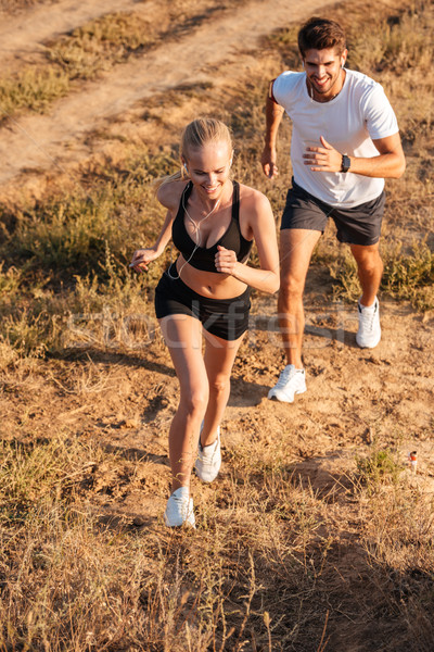 Athletic female runner and male fitness model running together Stock photo © deandrobot