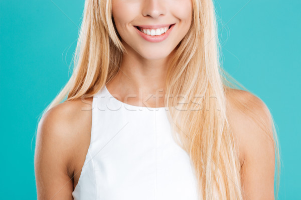 Cropped image of a smiling blonde woman in white top Stock photo © deandrobot