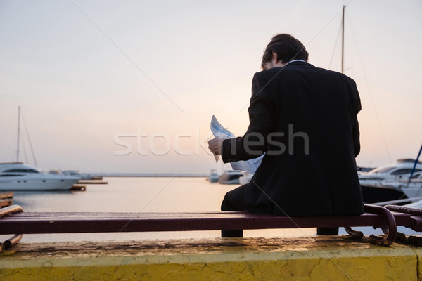 Back view of man in suit with newspaper Stock photo © deandrobot