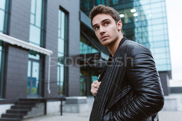 Serious Business man standing sideways Stock photo © deandrobot