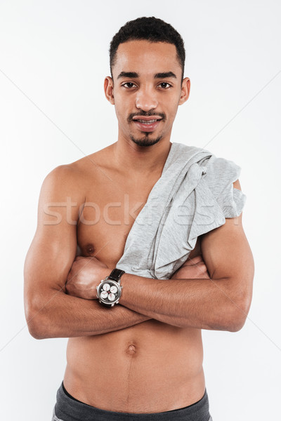 Handsome african man posing over white background Stock photo © deandrobot