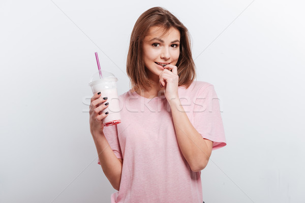 Cheerful young woman holding cocktail Stock photo © deandrobot
