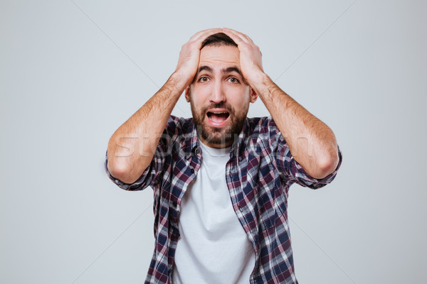 Overwhelmed bearded man in shirt Stock photo © deandrobot
