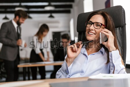 Heiter Geschäftsfrau Sitzung sprechen Handy Büro Stock foto © deandrobot