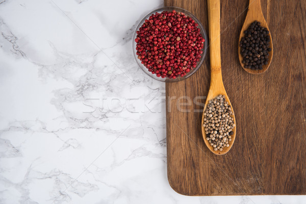 Multicolored pepper peas in wooden spoons Stock photo © deandrobot