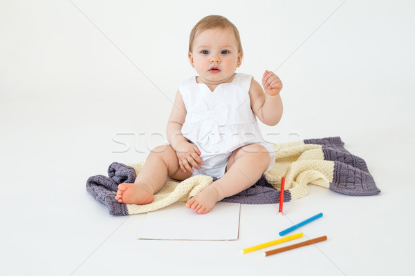 Pretty little girl sitting on floor on plaid holding markers Stock photo © deandrobot