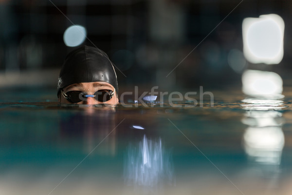 Close up of the top of a male swimmers head Stock photo © deandrobot