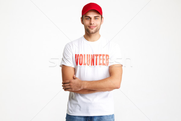 Portrait of a confident smiling man wearing volunteer t-shirt Stock photo © deandrobot