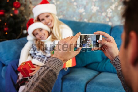 Cropped view of father taking photo of his wife and daughter in  Stock photo © deandrobot