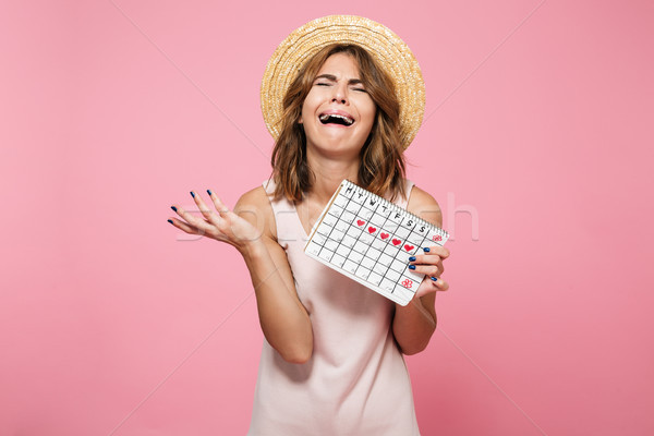 Portrait of an upset desperate girl in summer hat Stock photo © deandrobot