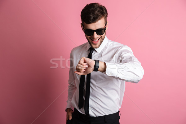 Portrait of a smiling attractive man in white shirt Stock photo © deandrobot