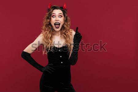 Happy punk woman screaming and holding her head Stock photo © deandrobot