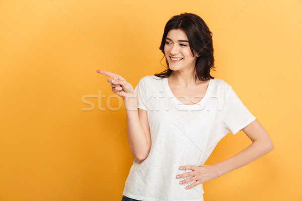 молодые женщину указывая фото Постоянный Сток-фото © deandrobot