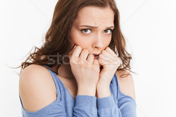 Close up portrait of a scared young woman Stock photo © deandrobot