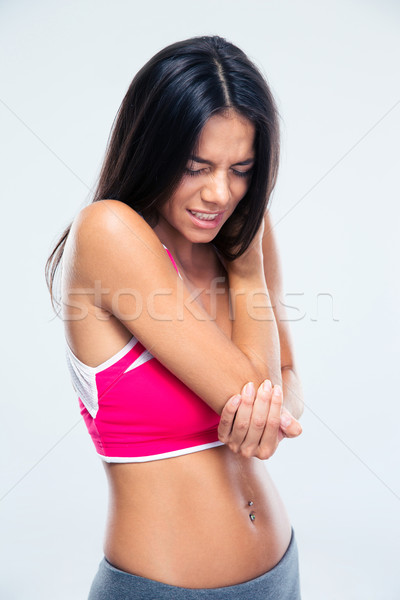 Fitness woman with elbow pain Stock photo © deandrobot
