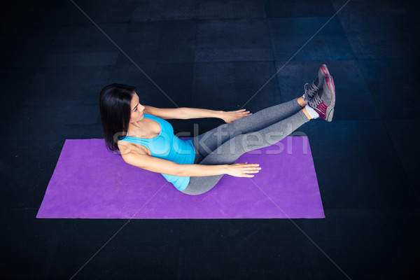 Woman doing excercise on yoga mat  Stock photo © deandrobot