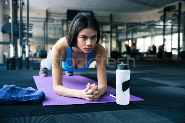 Beautiful fit woman working out on yoga mat Stock photo © deandrobot
