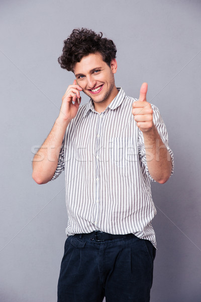 Happy man talking on the phone Stock photo © deandrobot