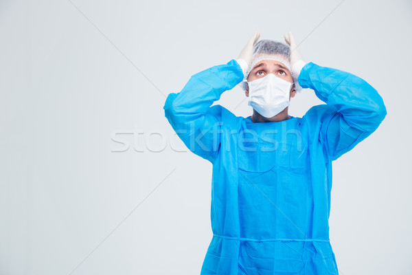 Porträt Ängstlichkeit Chirurg stehen isoliert weiß Stock foto © deandrobot