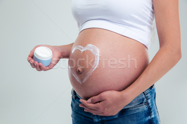 Pregnant woman with heart shape Stock photo © deandrobot
