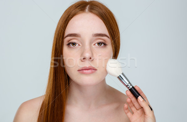 Redhair woman using makeup brush Stock photo © deandrobot