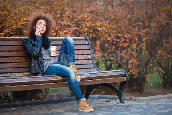 Stock photo: Woman talking on the phone in autumn park