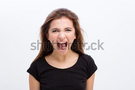 Mad angry young woman shouting with opened mouth Stock photo © deandrobot