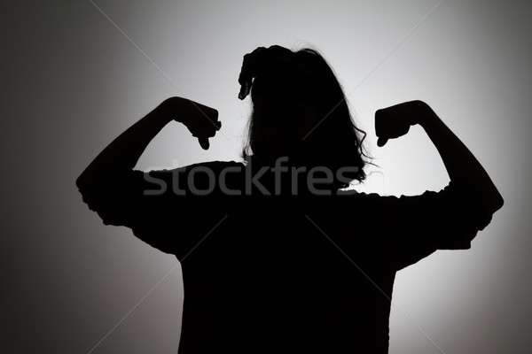 Sziluett nő mutat bicepsz mindkettő kezek Stock fotó © deandrobot