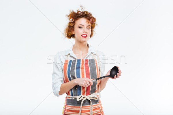 Housewife in apron holding soup ladle  Stock photo © deandrobot