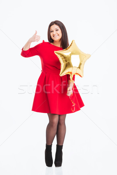 Happy woman holding balloon and showing thumb up  Stock photo © deandrobot