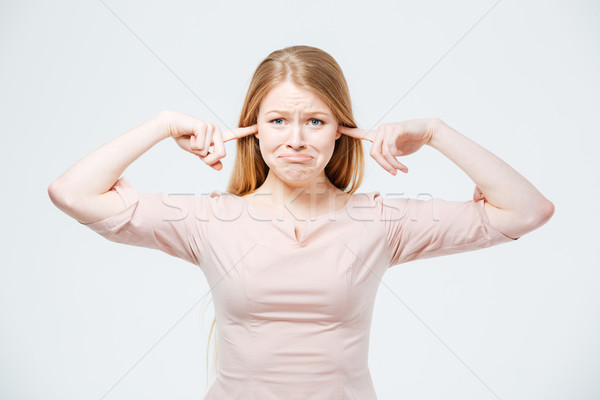 Sad woman covering her ears  Stock photo © deandrobot