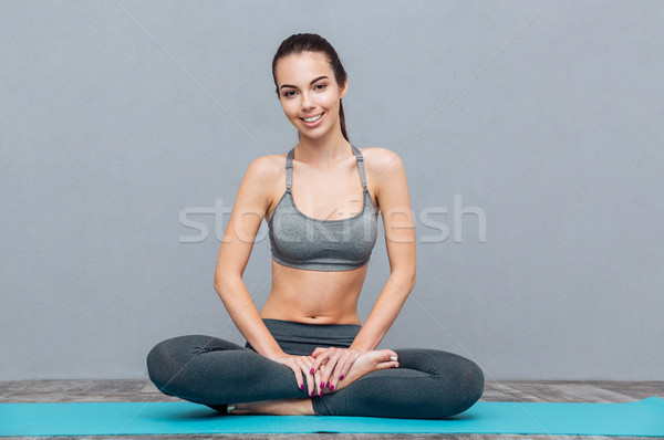 Portrait of beautiful girl in white sportswear doing yoga practice Stock photo © deandrobot