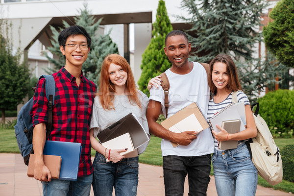 Stock photo: Cheerful young students standing together outdoors