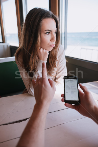 Vertical image of displeased woman on date with her man Stock photo © deandrobot